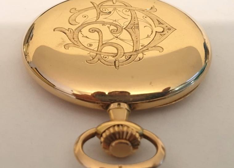 Swiss full hunter pocket watch in a 14ct gold case signed Haefliger Freres, Lucerne and c1900, with top wind and rocking bar time change. Outer case with monogram over a gilt dial with engine turned centre, black Arabic hours, blued steel hands and subsidiary seconds dial at 6 o/c. Jewelled lever movement with bi-metallic balance, gold case with 'ACD' maker's mark and numbered 112326.