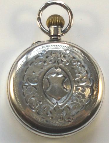 Ladies small ornate silver cased fob watch with swiss cylinder movement, top wind and rocking bar time change. White enamel dial with hairline crack, gilt decoration and minute track, black arabic hours and blued steel hands. Case stamped .925, with London import hallmarks for 1910, numbered #5891.