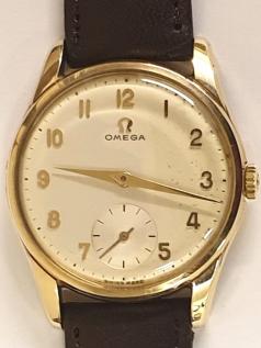 Swiss Omega manual wind wrist watch in a 9ct gold Dennison case hallmarked for Birmingham c1960 on a brown leather strap with gilt buckle. Signed light coloured dial with polished gilt Arabic hours and matching hands with subsidiary seconds dial at 6 o/c. Swiss made signed Omega model 923 calibre 267 17 jewel jewelled lever movement numbered 1779602 with case back signed and numbered 51489. The watch comes complete with original retail case and guarantee numbered 507906 and dated 21/2/62.