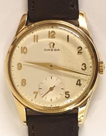 Swiss Omega manual wind wrist watch in a 9ct gold Dennison case hallmarked for Birmingham c1960 on a brown leather strap with gilt buckle. Signed light coloured dial with polished gilt Arabic hours and matching hands with subsidiary seconds dial at 6 o/c. Swiss made signed Omega model 923 calibre 267 17 jewel jewelled lever movement numbered 1779602 with case back signed and numbered 51489. The watch comes complete with original retail case and guarantee numbered 507906 and dated 21/2/62.