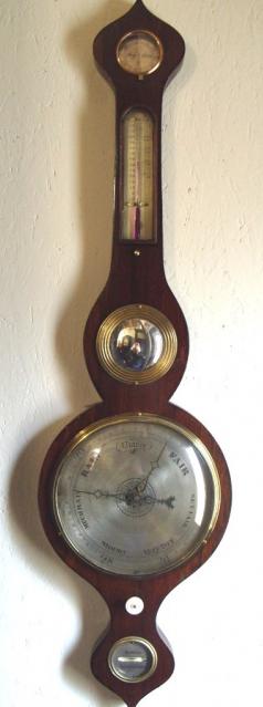 By Arnoldi of Gloucester, oak cased mercury barometer with onion style top and bottom, and silvered dials: - hygrometer, thermometer, convex mirror, barometer, an ivory hand adjuster and bubble level gauge.