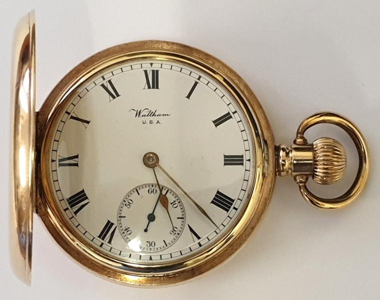 Early C20th American A.W.W Co. Waltham half hunter pocket watch in a Dennison gold plated case with top wind and time change. External blue Roman chapter ring on the outer case, internal white enamel dial with black Roman hours and gilt hands with a subsidiary seconds dial at 6 o/c. Signed American 15 jewel jewelled lever escapement with overcoil hairspring and split bi-metallic balance with micro adjuster, the movement numbered 16983845 and case numbered 724630.