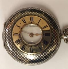 Swiss Omega half hunter pocket fob watch c1900, in a silver case with niello decoration and continental 0.900 marks, with top wind and time change. External black Roman hours on the gold chapter ring with internal white retail signed enamel dial with black Roman hours and gilt hands and subsidiary seconds dial at 6 o/c. Swiss Omega 15 jewel jewelled lever movement numbered 1893981 with overcoil hairspring and split bi-metallic balance, the case numbered 3026484.