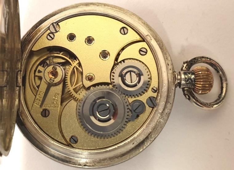 Swiss Omega half hunter pocket fob watch c1900, in a silver case with niello decoration and continental 0.900 marks, with top wind and time change. External black Roman hours on the gold chapter ring with internal white retail signed enamel dial with black Roman hours and gilt hands and subsidiary seconds dial at 6 o/c. Swiss Omega 15 jewel jewelled lever movement numbered 1893981 with overcoil hairspring and split bi-metallic balance, the case numbered 3026484.