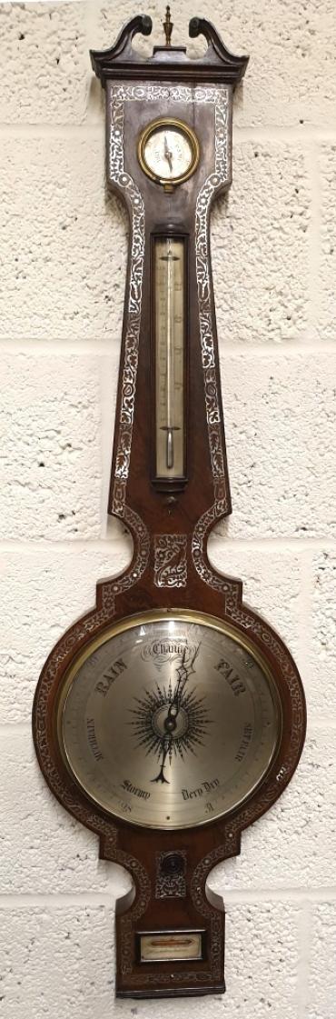English Georgian rosewood mercury wheel barometer with hygrometer and mercury Fahrenheit thermometer under a swan neck pediment with brass finial and throughout profuse decorative mother-of-pearl inlay. Circular brass bezel with convex glass over a silvered dial engraved with black inches of mercury pressure index and a blued steel pressure indicating hand with a gilt history marker. The alcohol spirit level indicator at the case bottom signed by 'Waymand' of 'Haddenham'.    Height - 45" and width - 13.5".