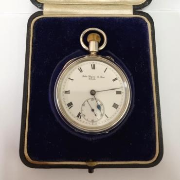 English silver cased pocket watch by John Dyson & Sons of Leeds in original plush velvet lined presentation box. Top wind and pin set rocking bar time change. White enamel dial with black Roman hours and blued steel hands with a subsidiary seconds dial at 6 o/c. 3/4 plate jewelled lever movement with going barrel numbered 375457 with silver case hallmarked for Birmingham c1910 and numbered 76760.