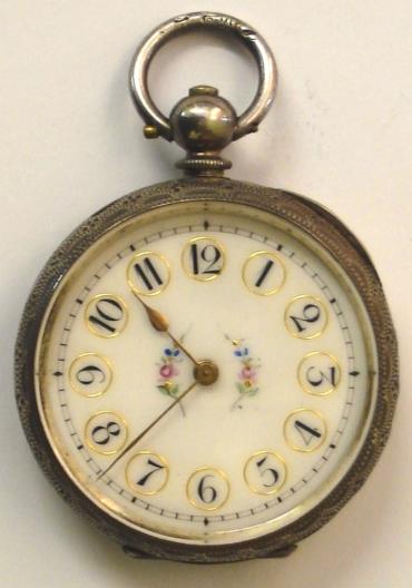 Silver swiss Ladies fob watch in an elaborately engraved case with vacant cartouche. Enamelled dial with decorative arabic hour markers with gilded surrounds, together with a central flower motif, and gold coloured spear and poker hands. Swiss key wound, split bar movement with cylinder escapement and jewelled to the third wheel, circa 1890.