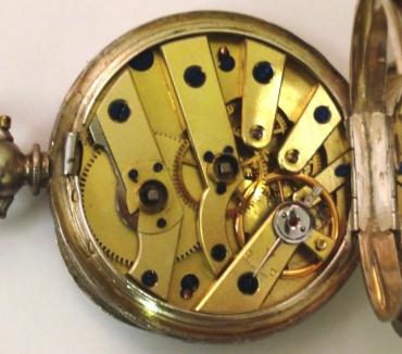 Silver swiss Ladies fob watch in an elaborately engraved case with vacant cartouche. Enamelled dial with decorative arabic hour markers with gilded surrounds, together with a central flower motif, and gold coloured spear and poker hands. Swiss key wound, split bar movement with cylinder escapement and jewelled to the third wheel, circa 1890.