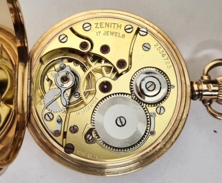 Swiss Zenith 9ct gold half hunter pocket watch in a Dennison case hallmarked for Birmingham c1920 with top wind and time change. Black Roman hours on the outer case and internal signed white enamel dial with black hours and blued steel hands with a subsidiary seconds dial at 6 o/c. High quality signed Swiss 17 jewel lever movement numbered 2536723 with micro regulator system, bi-metallic balance and overcoil hairspring. The English Dennison case is numbered 204418 and the watch is complete with the original retailer's plush lined case.