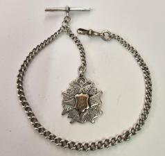 Silver graduated Albert watch chain hallmarked for Birmingham c1911 with 'T' bar, snap and decorative engraved silver and gilt medallion hallmarked for Birmingham c1906. Length 11", weight 35 grams.