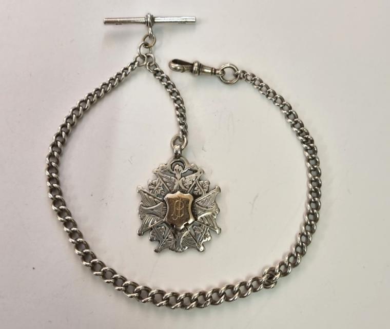 Silver graduated Albert watch chain hallmarked for Birmingham c1911 with 'T' bar, snap and decorative engraved silver and gilt medallion hallmarked for Birmingham c1906. Length 11", weight 35 grams.