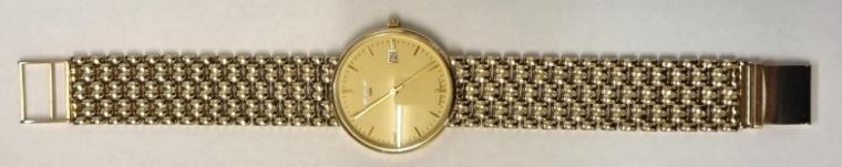 Modern Gents 9ct Gold quartz wrist watch by WHW circa 2005 and complete with original box and papers. 9ct gold case and integral bracelet with gilt dial and polished baton hour markers and matching hands together with a central seconds hand and date display at 3 o/c. Total watch weight - 55 grams.