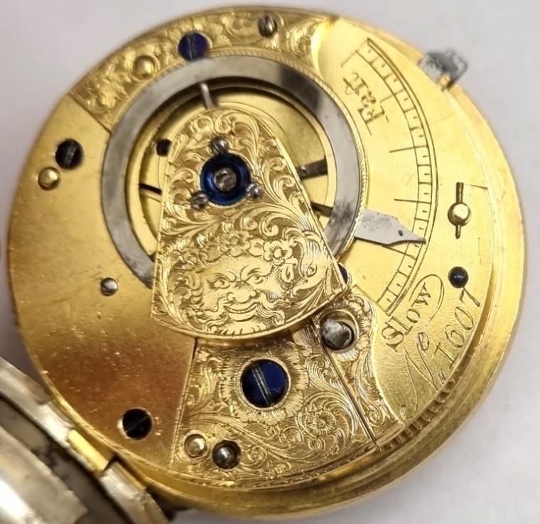 English unsigned silver cased verge fusee pocket watch hallmarked for London c1823. Key wind and time change with silver dial and gilt Roman hours and matching hands with blued subsidiary seconds hand. Silver coin edge case and engraved back plate with decorated cock piece and diamond end stone verge fusee movement numbered 1607.