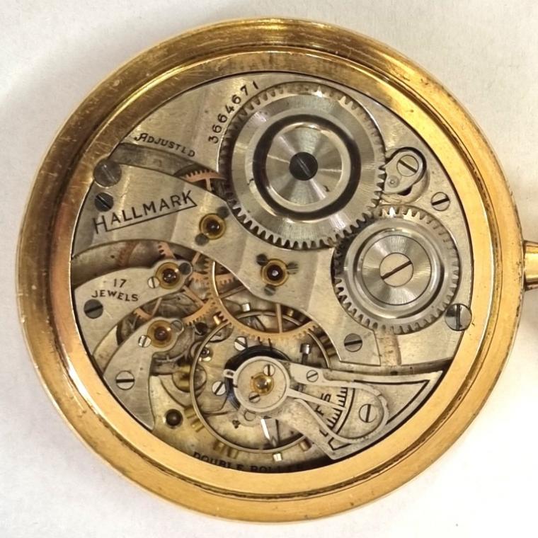Hallmark gold plated dress pocket watch with top wind and time change circa 1920/30s. Signed champagne coloured dial with black Arabic hours and blued steel moon style hands with subsidiary seconds dial at 6 o/clock. Signed adjusted 17 jewel jewelled lever double roller movement with split bi-metallic balance and breguet overcoil hairspring with micro adjuster and numbered 3664671. Signed gold plated case back guaranteed for 20 years and numbered 19178806.